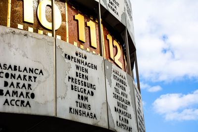 Low angle view of information sign against sky