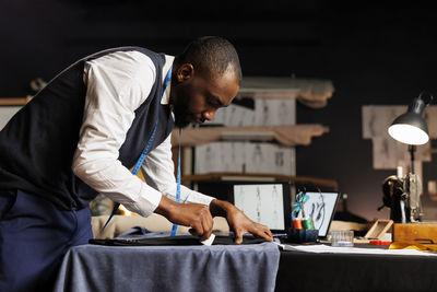 Side view of man working at office