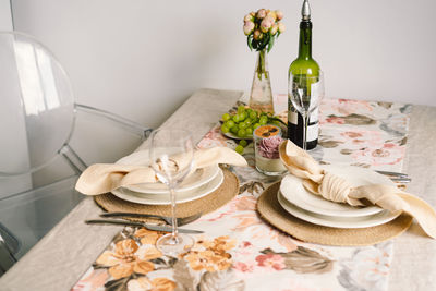 Vintage table setting with linen napkins and floral decorations. close up.