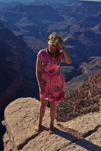 High angle view of woman standing on cliff