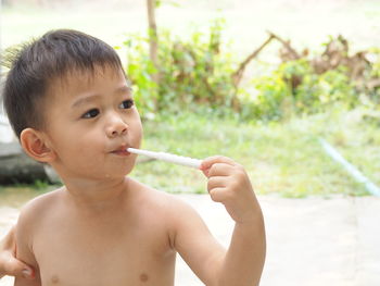 Close-up of boy brushing teeth