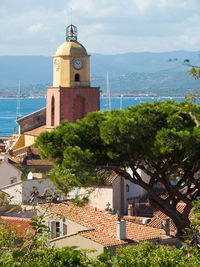 View of bell tower in town against sky