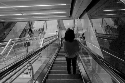 Rear view of woman walking in subway
