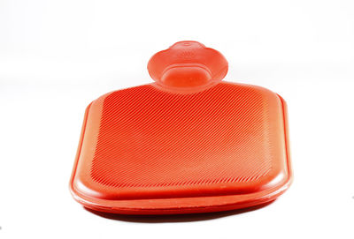 Close-up of red bottle against white background