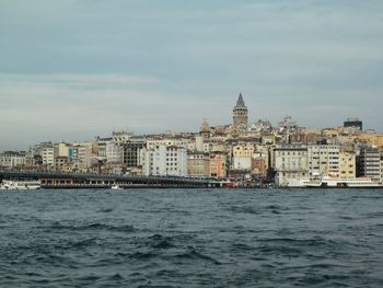 View of city at waterfront against sky