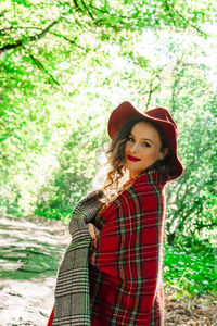 Portrait of woman standing at forest