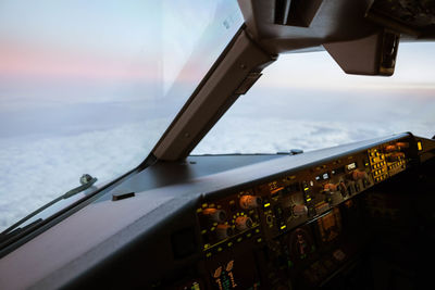 Low angle view of airplane window against sky