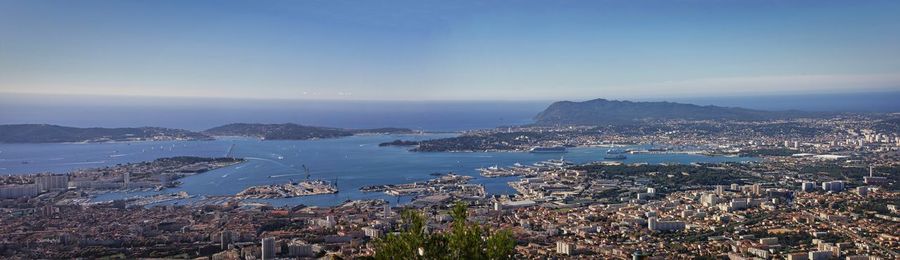 High angle view of townscape by sea against sky