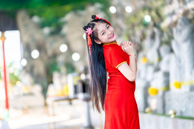 Portrait of young woman standing outdoors