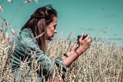 Side view of woman looking at camera