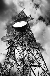 Low angle view of communications tower against sky