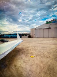 Airplane on airport runway against sky