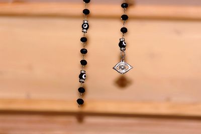 Close-up of chain hanging on wood