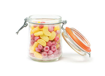 Close-up of glass of jar against white background