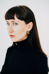 Close-up portrait of a young elegant woman over white background