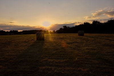 Scenic view of field against sky during sunset