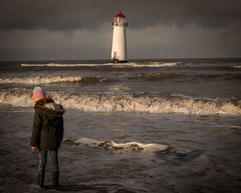 Rear view of man standing at beach