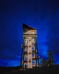 Low angle view of water tower against sky at night