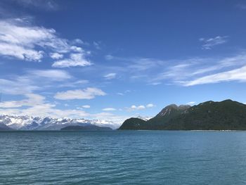 Scenic view of sea and mountains against sky