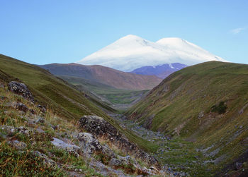 Scenic view of mountains against clear blue sky