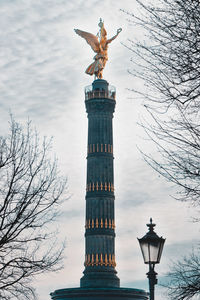 Low angle view of statue against cloudy sky