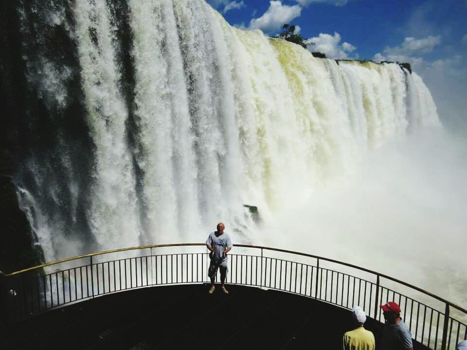 MAN STANDING ON RIVERBANK