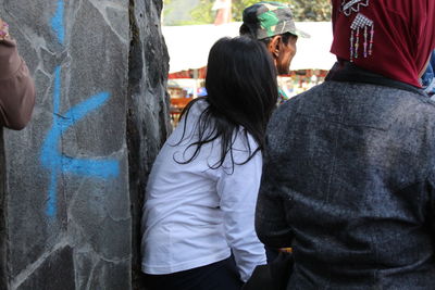 Rear view of people on street in city