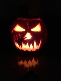 Close-up of illuminated pumpkin against black background