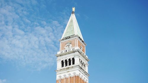 Low angle view of bell tower against blue sky