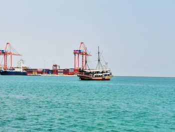 Sailboat in sea against clear sky