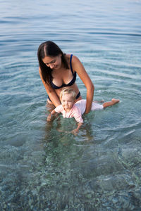 Young woman swimming in sea