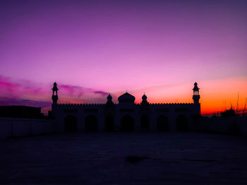 Silhouette of building against sky during sunset