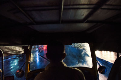 Rear view of man in bus