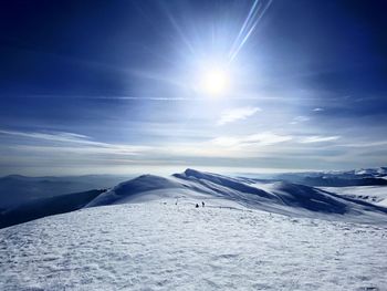 Scenic view of snow covered mountains against sky