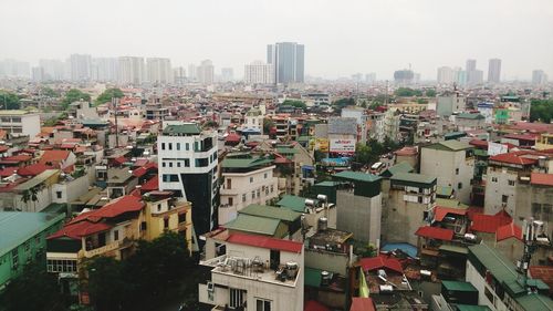 High angle view of buildings in city against sky