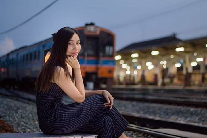 young adult, one person, long hair, rail transportation, hairstyle, hair, adult, beautiful woman, beauty, track, railroad track, railroad station platform, women, fashion, city, transportation, architecture, waiting, contemplation, outdoors