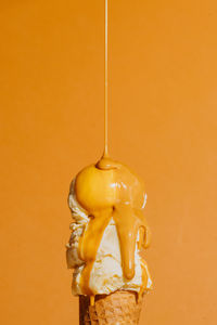 Close-up of trophy against yellow background