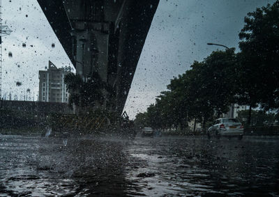 Water splashing on street in city during rainy season