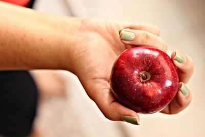 Close-up of woman holding apple