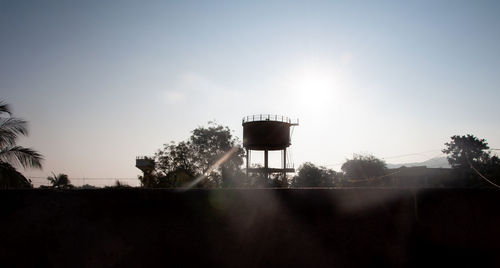 Silhouette of water tower against sky