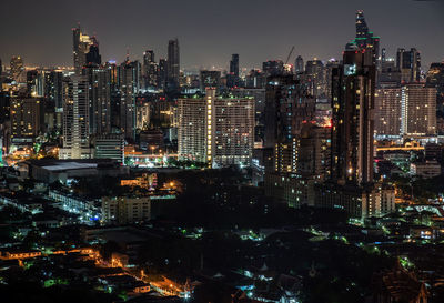 Illuminated cityscape against sky at night