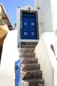 Low angle view of staircase against blue wall