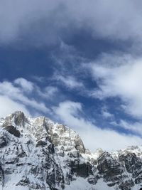 Low angle view of snowcapped mountain against sky