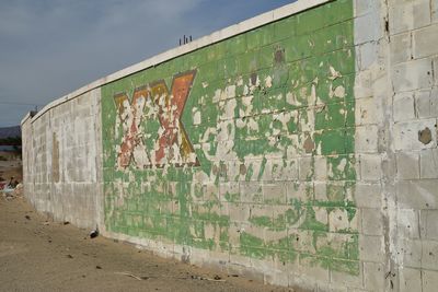 Graffiti on wall against sky