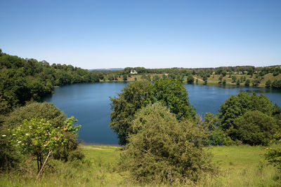 Scenic view of lake against clear blue sky