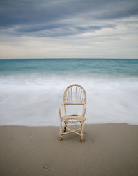 Lonely chair in the dawn of a cloudy day