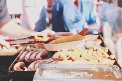 Cropped hands of man holding food for sale at market