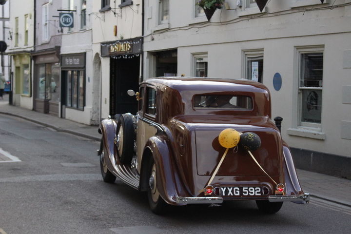 VINTAGE CAR ON STREET IN CITY