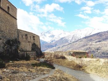 Scenic view of mountains against cloudy sky