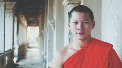 Portrait of beautiful young woman standing in corridor